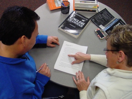 MCC Writing Center consultant helping a student with his paper